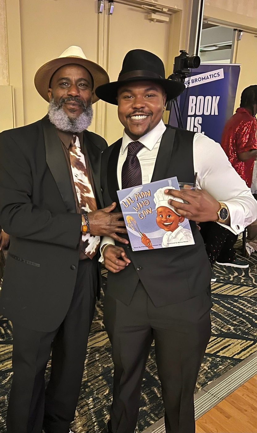 d'Artagnan J. Connor and d'Artagnan Connor Sr. with the Lil Man Who Can book